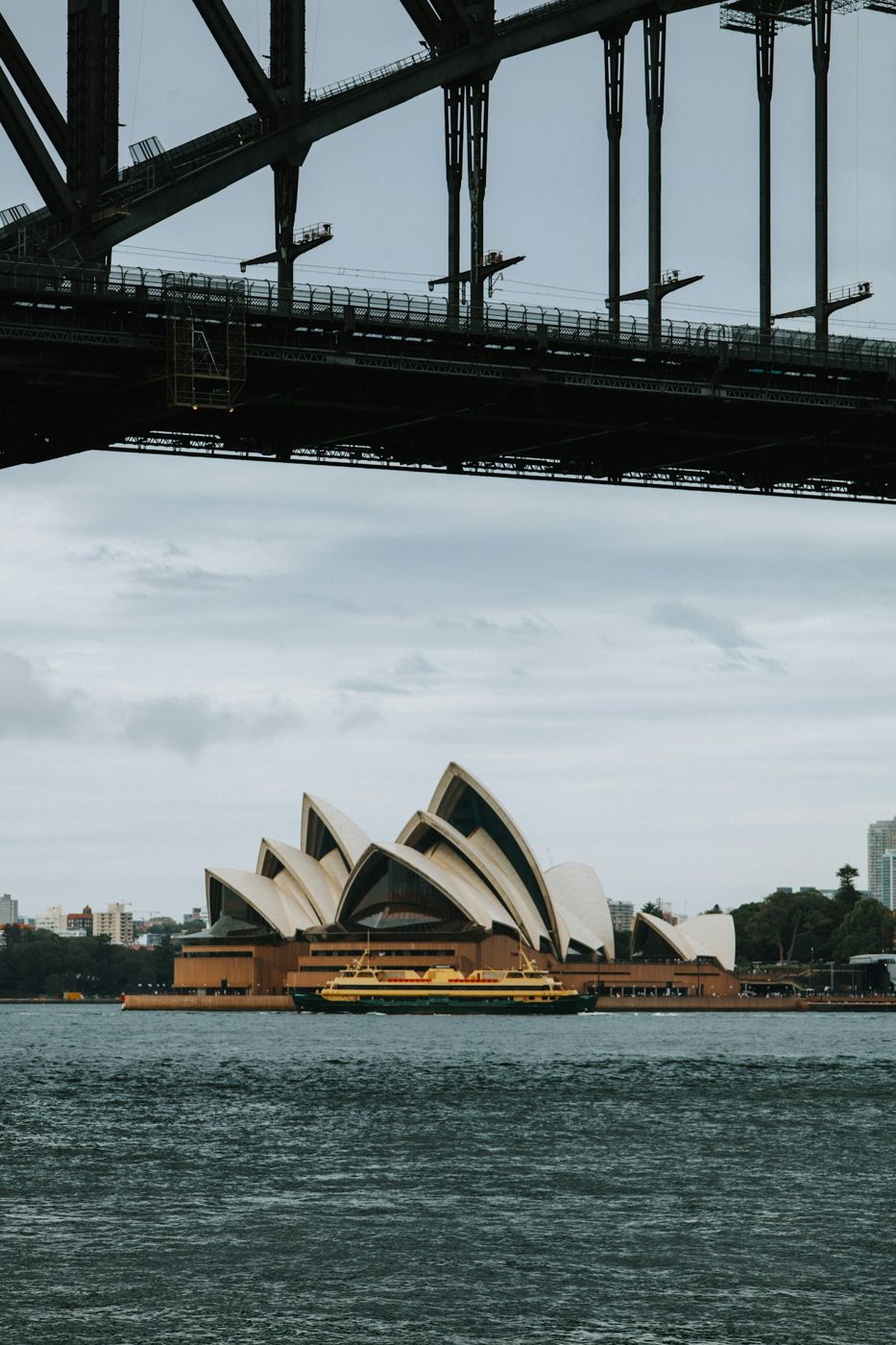 Sydney Opera House framed by the steel structure of the Harbour Bridge