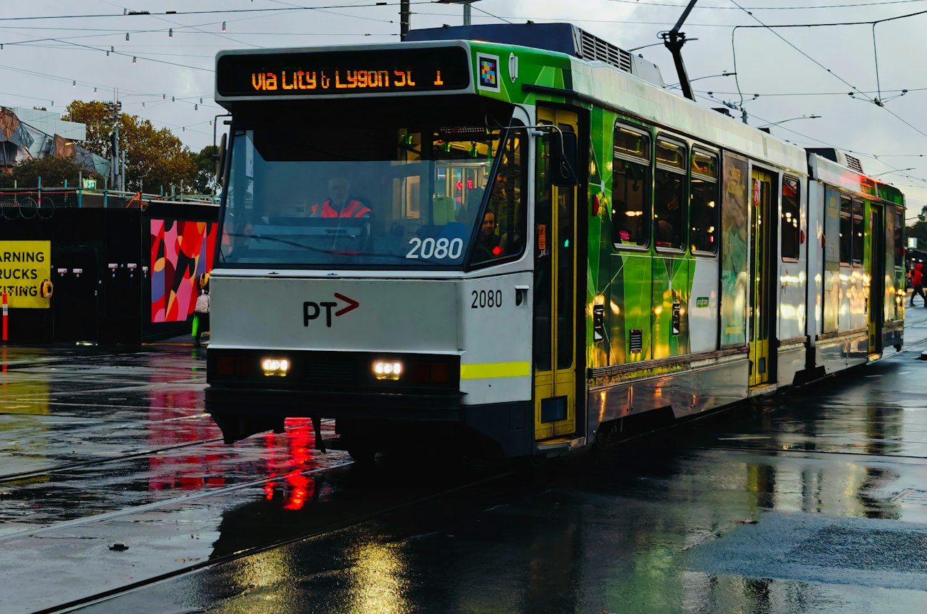 A Melbourne tram on rain-soaked city tracks
