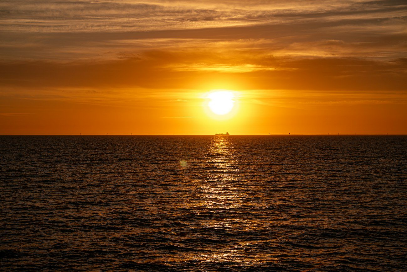 The sun setting over the water at St Kilda