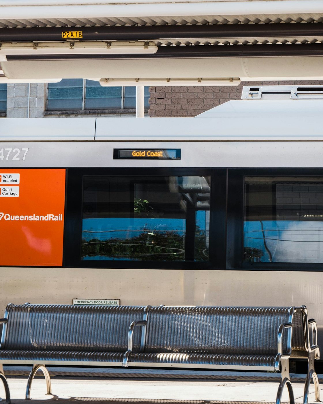 A Queensland passenger train beside a platform