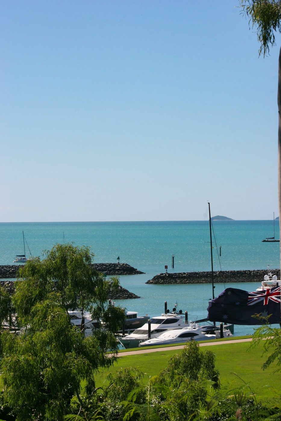 Boats near Airlie Beach beneath a clear blue sky