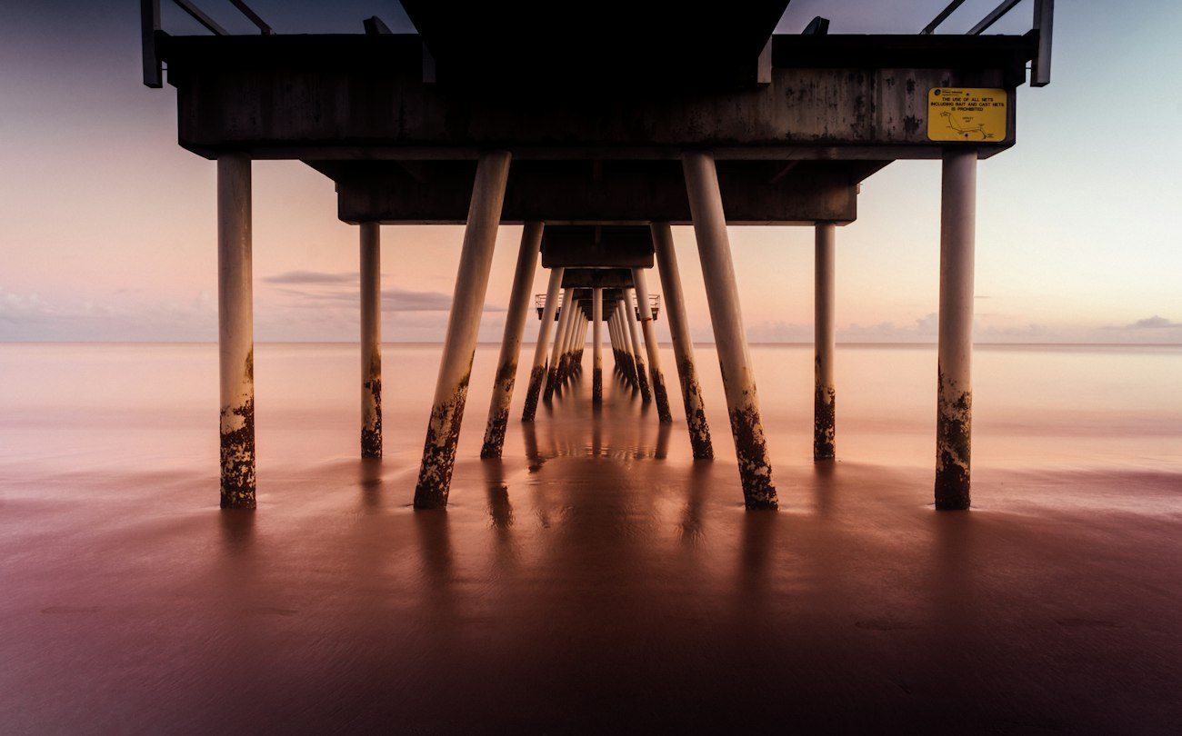 The underside of a Hervey Bay jetty at sunset