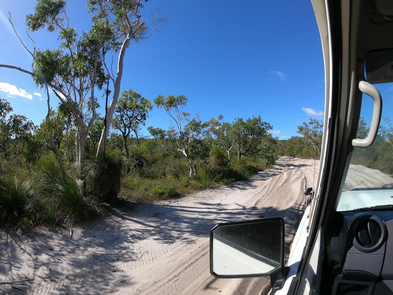 A sandy track seen from a four-wheel-drive vehicle on K'gari