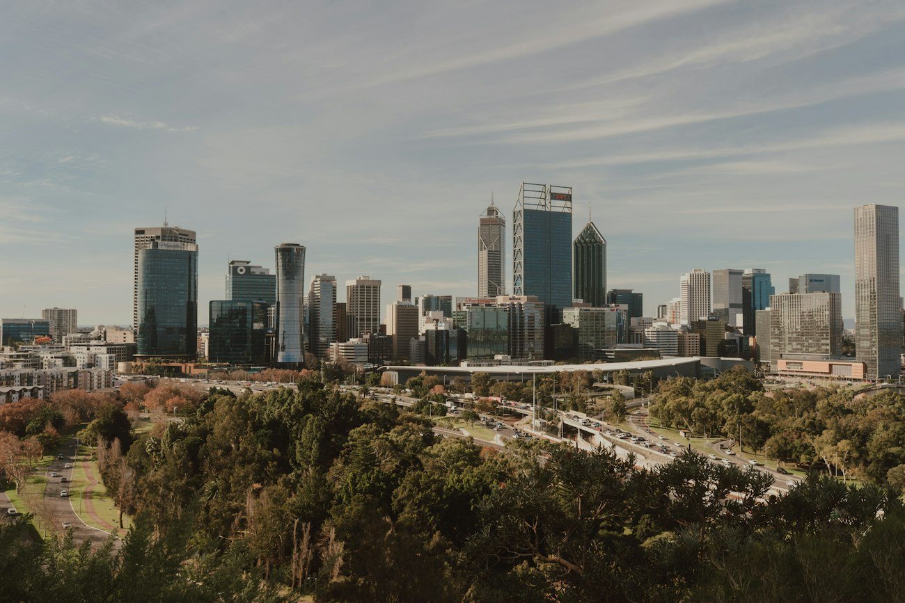 Perth city buildings beyond parkland and trees