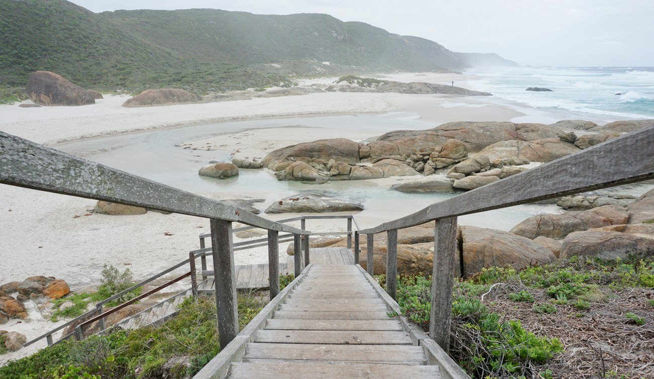 Stairs descending to a rocky Margaret River beach