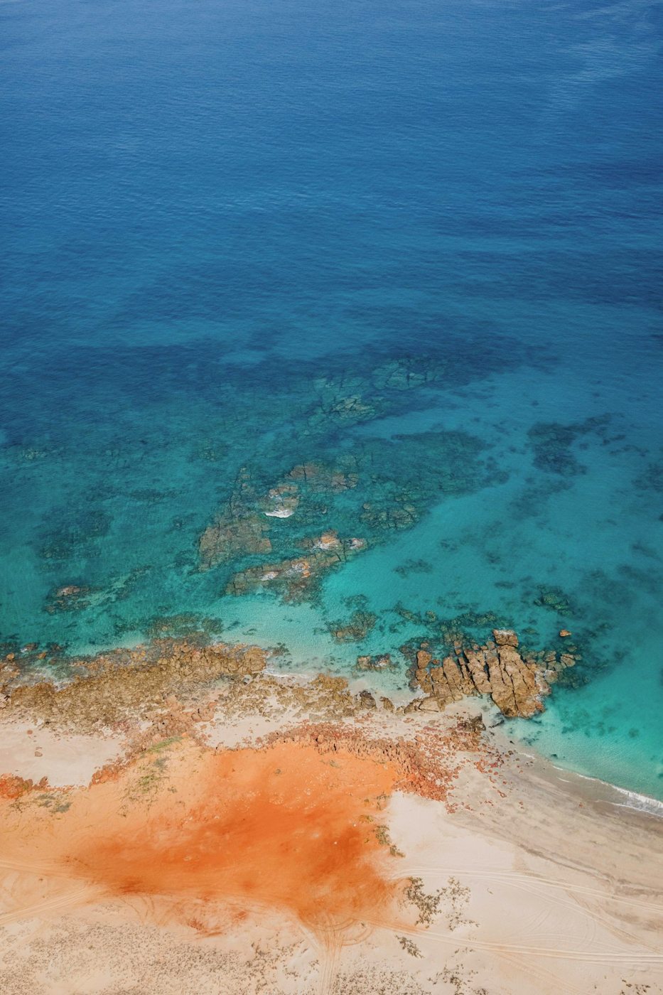 Red earth meeting clear blue water near Broome