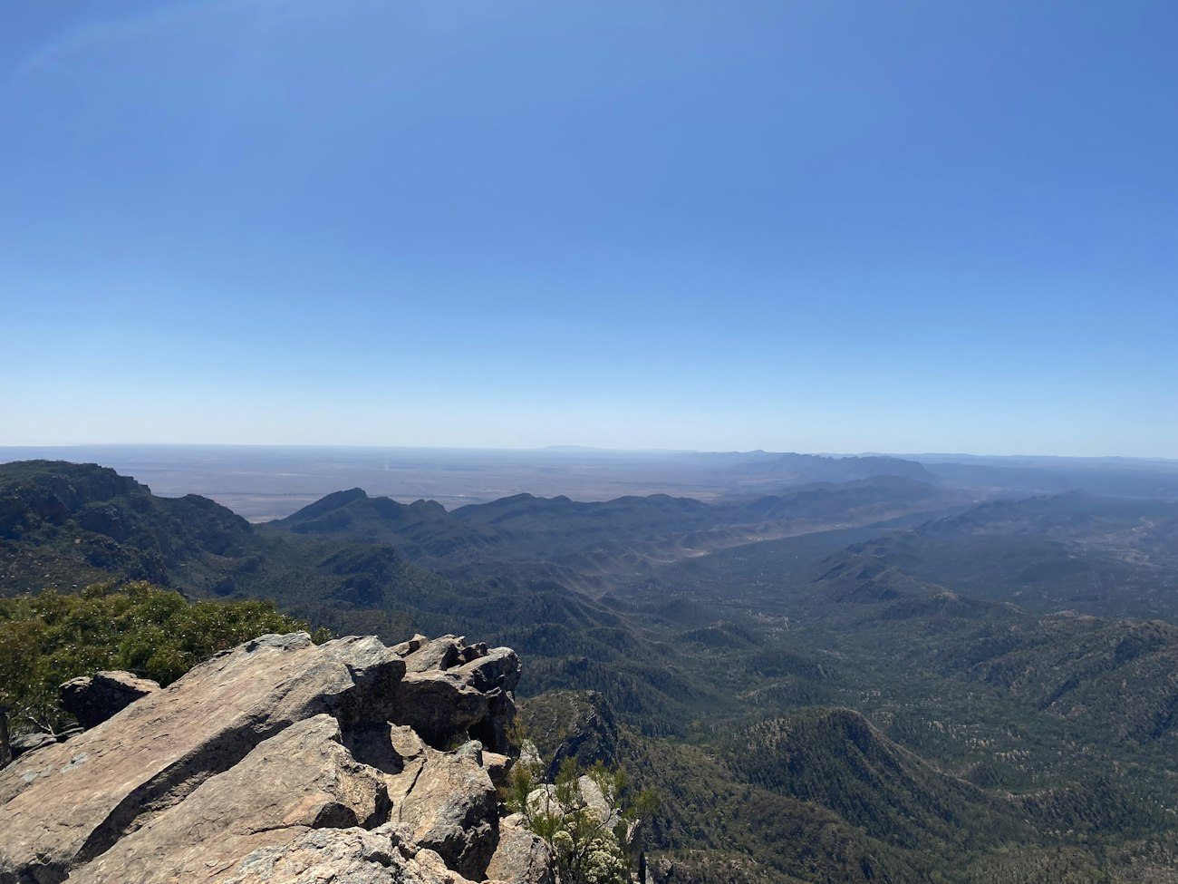 A rocky viewpoint overlooking Wilpena Pound and surrounding ranges