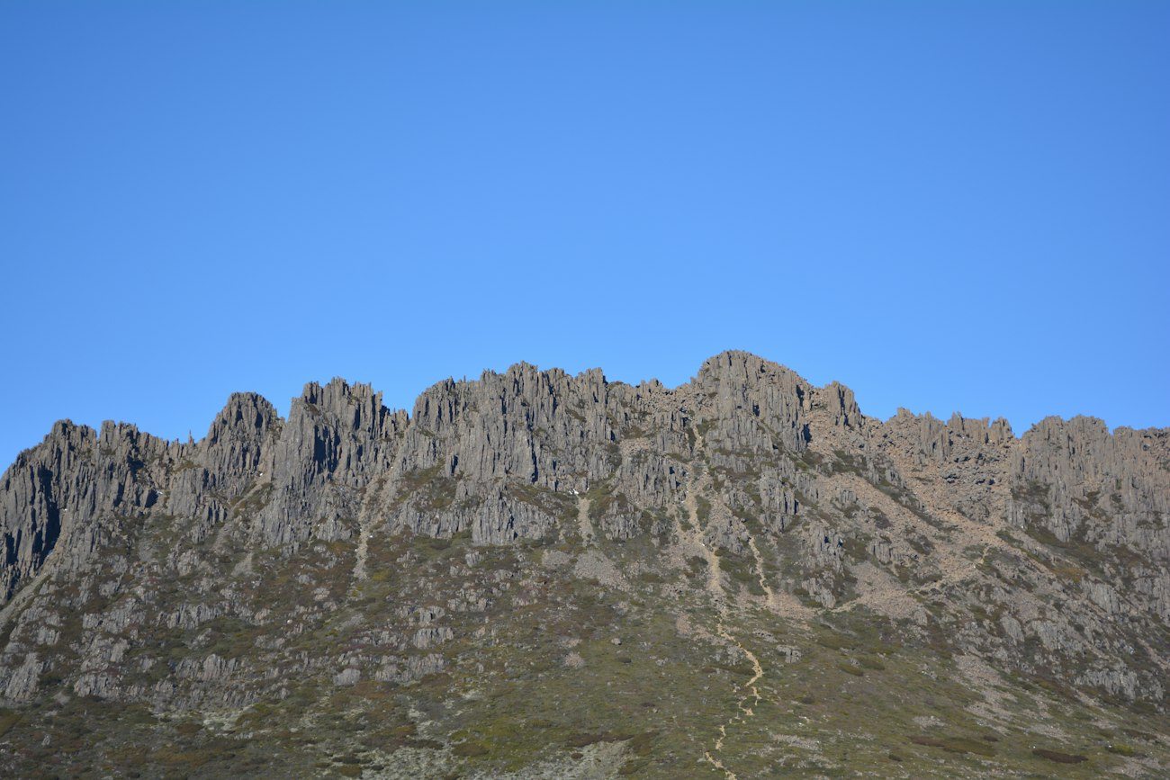 Cradle Mountain's rugged summit beneath a blue sky